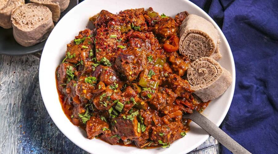 A plate of Ethiopian awaze tibs with a side of injera.