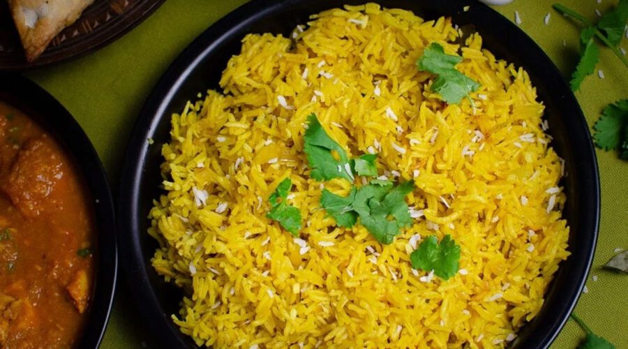 A plate of creamy Tanzanian coconut pilau with garnish