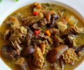 A plate of Nigerian pepper soup with assorted meats