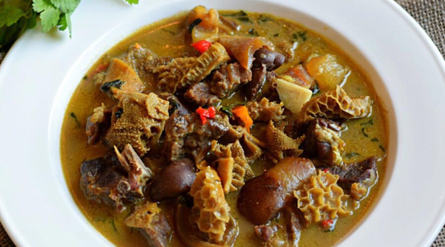 A plate of Nigerian pepper soup with assorted meats