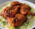 Peri Peri chicken thighs served with lettuce in a pan