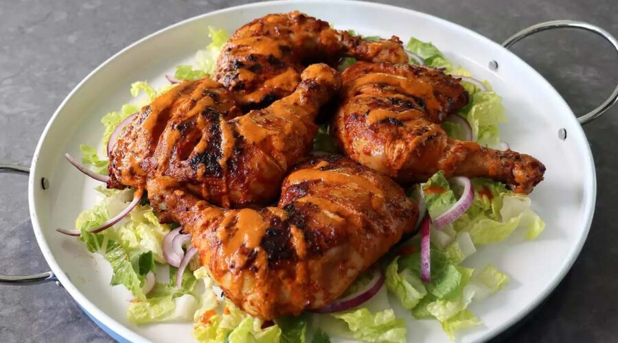 Peri Peri chicken thighs served with lettuce in a pan