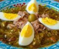 Plate of Mechouia salad with boiled eggs and an olive in the middle