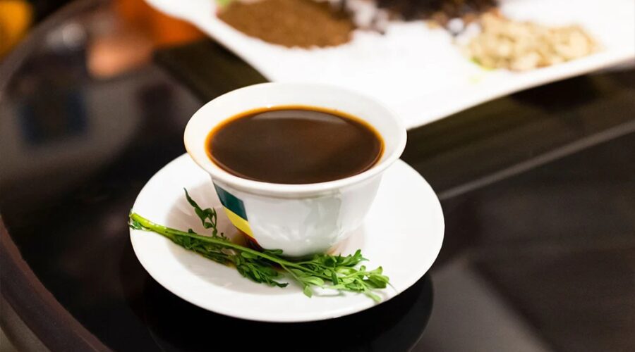 A steaming cup of rich, aromatic Ethiopian coffee, showcasing its dark hue and inviting steam, ready to be savored.