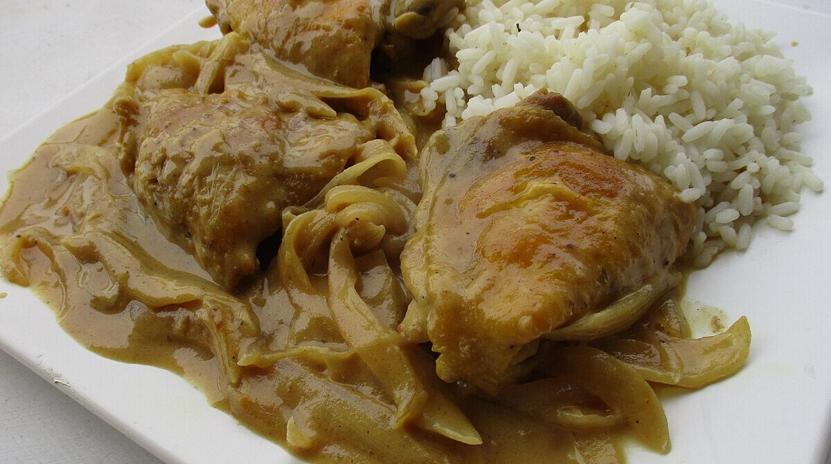 Senegalese chicken yassa in onion sauce served with white rice
